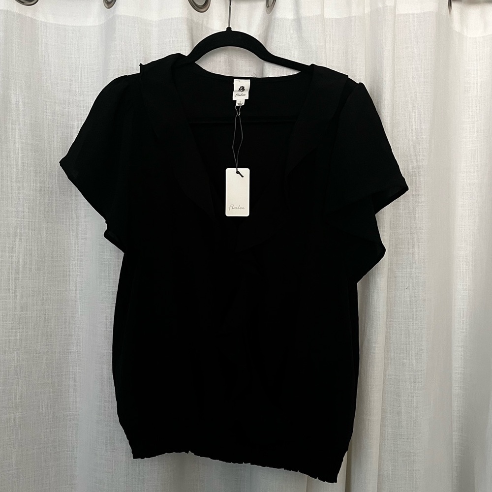 Black shirt- flowy sleeves, snap front closure.